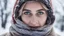 Placeholder: Eyes and winter, a woman in the snow, wears a scarf wrapped around her neck and her eyes are visible