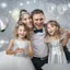 Placeholder: Photograph of a happy couple with kids celebrating with silver party decoration.