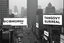 Placeholder: greyscale cityscape; many large white billboards populate the city with black block lettering with single word text "BIOMORPH", or "CB", or "SPATCHCOCK", or "TANGUY", or "SURREAL", 'They Live' movie by John Carpenter movie still, modern movie city panoramic, concept art