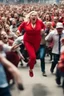 Placeholder: an obese terrified blonde woman in a red pant suit desperately running away from an angry mob of hundreds of people chasing her from behind