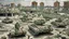 Placeholder: Israeli soldiers and tanks stand on a very large chessboard in the middle of a destroyed city