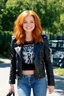 Placeholder: Debby Ryan, smiling, Heavy Metal t-shirt, Black Leather biker's jacket, midday, bright sunlight, extremely colorful. Big, fluffy hair, Debby Ryan has Auburn Red hair, green eyes, She is extremely well built.....Well endowed.