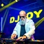 Placeholder: A dj on a night rave club standing mixing songs , he looks like walter white kinda, bald with beard. strobes and blue yellow light, a big sign with "DJ ROY" in the background, this is a album cover for his dj roy essentials album.