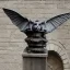 Placeholder: A magical gothic cat gargoyle with goat horns and wings the size of a cat Nick Harris style