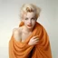 Placeholder: A photograph of childish marilyn monroe, head backwards , hand on heart, with spiky hair, no make up, in the style of milton greene, a pale orange silk scarf around her shoulders, white bacground