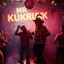 Placeholder: "MR Kukrunk" is Benny, and "DJ Roy" in a disco, dancing, "MR Kukrunk" on sign wall, disco light, strobe, smoke. disco ball, 1000 dancing people