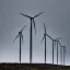 Placeholder: Thousands vertical wind turbines. Heavy cold rain. Strong wind. An engineer looking up. Futuristic scenary. Metallic mist.