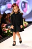 Placeholder: 2 years old german baby girl with clothing like fashion model with pretty high heels in runway with flowers