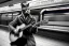 Placeholder: One single mature cat, perfect iris,guitar case, wearing clothes, sitting in the subway, Vienna, friendly, model style, hyper realistic, extremely accurate, delicate, extremely detailed, Graphic novel style, wide-angle, open aperture, superfine pencil