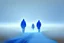 Placeholder: two people seen from behind walking side by side in an empty foggy plain, above there is blue sky