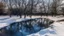 Placeholder: The pond is half frozen, today the sun was shining, the water had a stunning blue colour