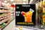 Placeholder: satirical product advertisement, Trojan brand black and gold sandwich bag box on display on a grocery store shelf, "RIBBED SANDWICH BAGS", picture on box is a long tubular hot dog bun poking out of an opaque yellow crenelated plastic bag, photorealistic, HD, natural lighting, Trojan brand logo