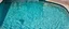 Placeholder: the rippled surface of the water in a pool, just the watter