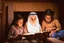 Placeholder: A close-up scene of an Arab mother reading the story from a book with her children around her in the room of the old wooden house near the fireplace 100 years ago.