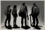 Placeholder: four persons, standing, silhouette, comic book,post-apocalypse, gray background, backpack,