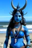 Placeholder: A photo of a blue skin Hindu goddess with painted blue face and body skin, wavy black hair deer antlers standing on a sunny beach