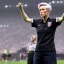 Placeholder: Megan Rapinoe in a referee jersey officiating for a soccer match at Wembley Stadium