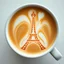 Placeholder: close up top-down view of a latte with the Eiffel tower formed in the milky foam, professional photography, looks like an advertising campaign photo, delicious