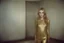 Placeholder: Sharon tate, without a face, , hippie girl, gold body in a liminal empty room, old autochrome