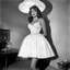 Placeholder: [high res photo by Russ Meyer] the bottom of her dress is a Lampshade, light from inside, view from below [spanish fiesta]