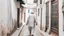 Placeholder: Rear view of an elderly Moroccan walking in a Moroccan alley with white walls