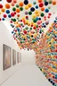 Placeholder: art exhibition displaying small pompoms in a whimsical ambience
