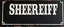 Placeholder: fill composition with large and wide historical hand painted old western sign that reads: "SHERIFF" white on black with inset white stripe boarder aged paint on wood sanserif