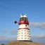 Placeholder: a white and red Dalek as a light house