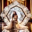 Placeholder: very beautiful fachion lady sitting inside a very big fantezy diamond wearing nice bride, lights reflecting on diamod and her jewels