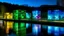 Placeholder: River power plant at night, illuminated glass blocks casting colorful light patterns on the walls, surrounded by a serene water landscape, showcasing the interplay between industry and nature.