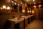 Placeholder: Pictures of a group of bathrooms in Mathaf Restaurant. The walls and floors are in brown tones, and the sinks are on one wall.