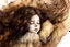 Placeholder: Small girl with long curly brown hair sleeping in god's hand watercolor and ink, golden patina, glitters in ochre, backlit, mist and fog