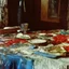 Placeholder: Close up polaroid photography of spooky room, eerie, table, Max Ernst, hypnotic, obsessive, hypermaximalist, colors, details of the table very accentuated, filthy pieces of dismebered body, strong contrasts and dynamism