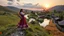 Placeholder: an Azeri lady and man are dancing togather to camera in village over high grassy hills,a small fall and river and wild flowers at river sides, trees houses ,next to Ripe wheat ready for harvest farm,windmill ,a pretty train is arriving to station along river,a few village local shops ,cloudy sun set sky