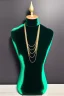 Placeholder: dark green velvet Necklace Mannequin Stand on a luxury table