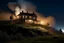 Placeholder: A house on top of a hill with smoke rising from it at night