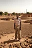 Placeholder: Sudan, destroyed city, one man standing