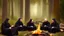 Placeholder: Black robed monks sitting around a fire in the forest