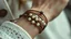 Placeholder: macro photo of a bracelet made of brown leather and little pearls on a woman's wrist, detailed, sharp contrasts, realistic, cinematic, blur background