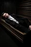 Placeholder: a man in black suit, white shirt, black pants, black shoe sleeping in a coffin