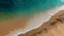Placeholder: l'eau sur du sable vu du dessus
