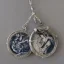 Placeholder: pendant in a form of two conjoined silver coins, watercolor, large strokes, illustration, fantasy