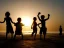 Placeholder: children playing on the Indian beach capture them against the sun and make an art silhouette, hyper details, real sharp, 8k, well detailed, well shaped