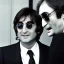 Placeholder: Tom Snyder in a suit leaning forward as he interviews John Lennon, 1980s