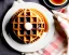 Placeholder: Round waffle with maple syrup plate, plaid napkin fork tines