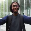 Placeholder: A long haired, black male software engineer taking a selfie in front of Building 92 at Microsoft in Redmond, Washington