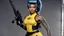 Placeholder: A Nichelle Nichols warrior with a machine gun covered by tattoos, 24-years-old her lean muscular frame wrapped in a yellow tactical two-pieces bodysuit and a bullet proof vest over her bossom. Her hair is pulled back in a tight ponytail, revealing blue eyes [vintage style noisy scratches glitches, Shot the texture and then rewound the film and double exposed from a 1970 B series movie] she stands on the balcony of the marble palace of a modern dictator, behind we see the beach and palm trees