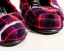 Placeholder: Red plaid slippers on a fur rug by kiva