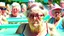 Placeholder: older lady pouting at a crowded water park