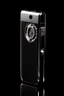 Placeholder: Black cigarette lighter containing a watch engraved with white gold